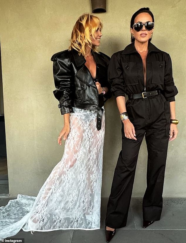 The P.E Nation founder, 43, wore a black bra and matching underwear underneath a white lace skirt and a Saint Laurent leather bomber jacket as she posed and preened alongside her best friend, Melbourne socialite Sarah Lew, at the track. Both pictured