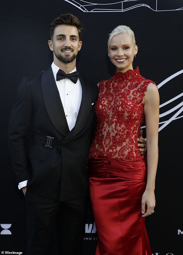 The AFL star was accompanied by girlfriend Annaise Dalins who looked divine in red