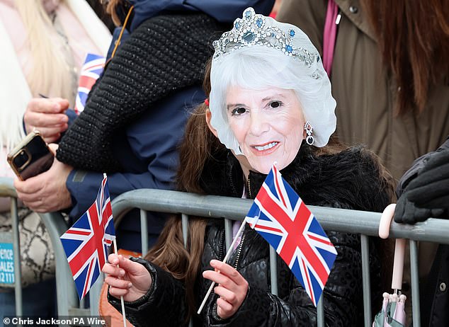 Members of the public await the arrival of Camilla in Shrewsbury today as they wear masks