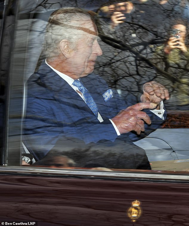 King Charles III waves to smiling members of the public as he leaves Clarence House today