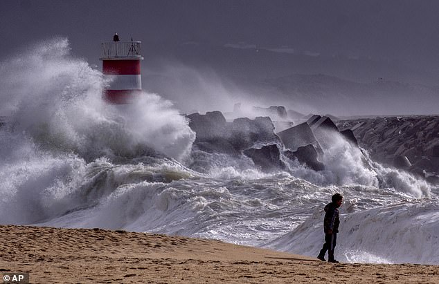 PORTUGAL -- Big waves strike the beach of Nazare in Portugal yesterday amid Storm Nelson