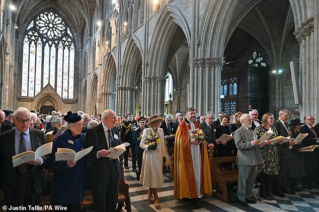 Queen Camilla walks with interim Dean of Worcester Cathedral, Reverend Canon Stephen Edwards, at the Royal Maundy service this afternoon