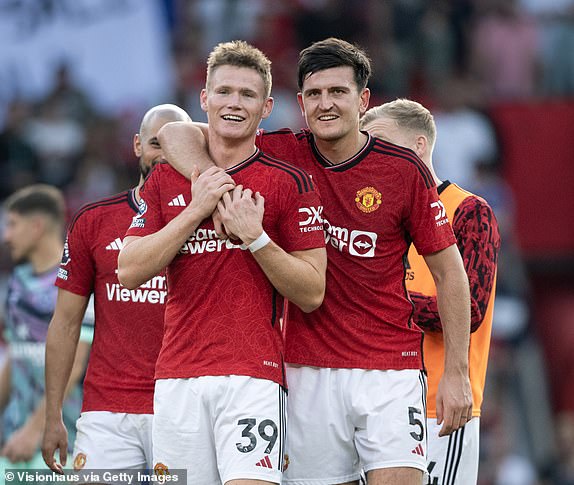 MANCHESTER, ENGLAND - OCTOBER 7: Manchester United's winning goal scorer Scott McTominay smiles with team mate Harry Maguire after the Premier League match between Manchester United and Brentford FC at Old Trafford on October 7, 2023 in Manchester, England. (Photo by Joe Prior/Visionhaus via Getty Images)