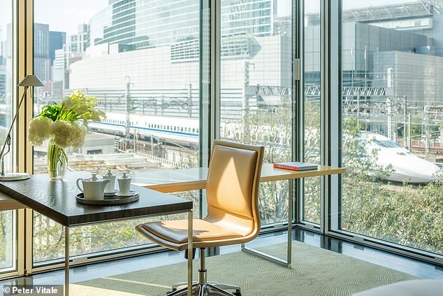 Ailbhe MacMahon checks into Four Seasons Hotel Tokyo At Marunouchi where she watches bullet trains slowly pulling in and out of Tokyo Station. Pictured: The view from a Deluxe Premier Twin room at the hotel