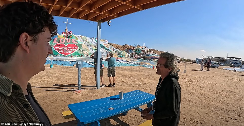 Filmmaker Ryan Twomey said he had 'always been interested' in Slab City - which he describes as 'one of the last free places in America' - so he decided to make it the focus of one of his latest YouTube videos. Above, speaking to a resident called Wolf
