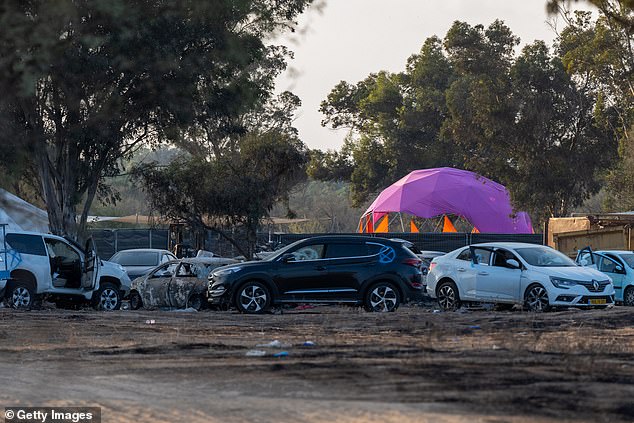At the Nova music festival and nearby, UN envoy Patten said, 'there are reasonable grounds to believe that multiple incidents of sexual violence took place with victims being subjected to rape and/or gang rape and then killed or killed while being raped'. Pictured: Destroyed and damaged cars are left on the side of the road at the site of the Nova festival