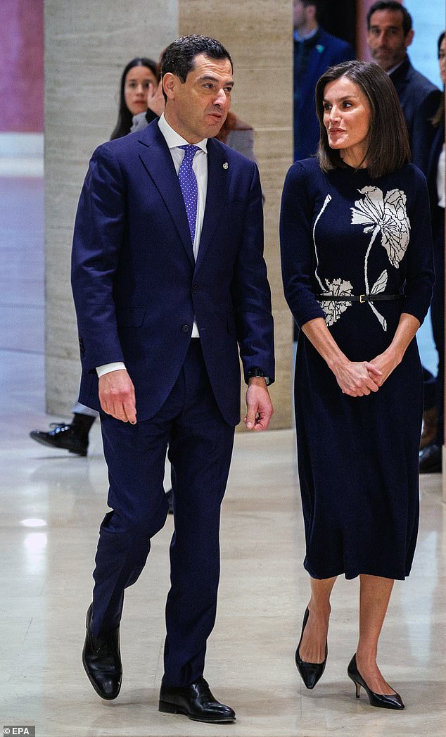 Auf dem Bild mit der andalusischen Präsidentin Juanma Moreno trug Königin Letizia von Spanien ein stilvolles gestricktes Midikleid in Marineblau vom spanischen Designer Galcon Studio, als sie am Dienstag, dem 5. März, an einer Veranstaltung zum Welttag der seltenen Krankheiten in Sevilla teilnahm