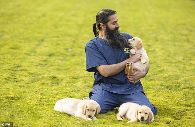 The charity GuideDogs says that many dogs are scared of men with beards because they never met any while young. Try to introduce your dog to people with distinctive facial features