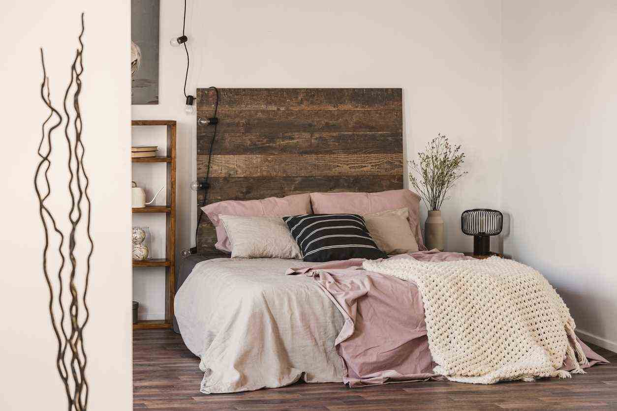 Black And White Pillow On Pastel Pink And Beige Bedding