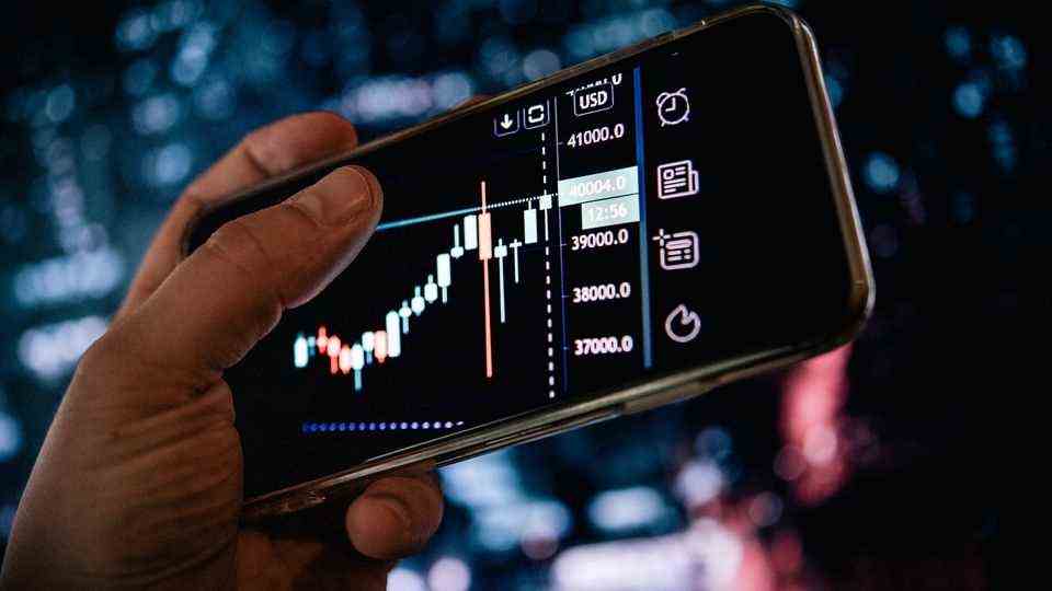 Inflation: A smartphone display shows fluctuating stock prices