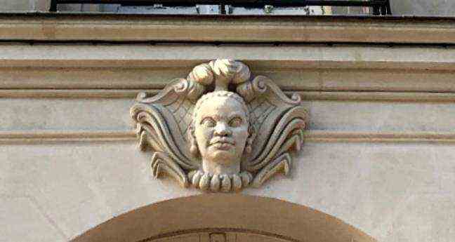 An African face mascaron on a facade of Allée Brancas, near Place du Commerce, in Nantes.