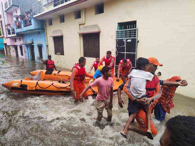 Rescuers evacuate residents in northern India's Uttarakhand state on October 19, 2021.