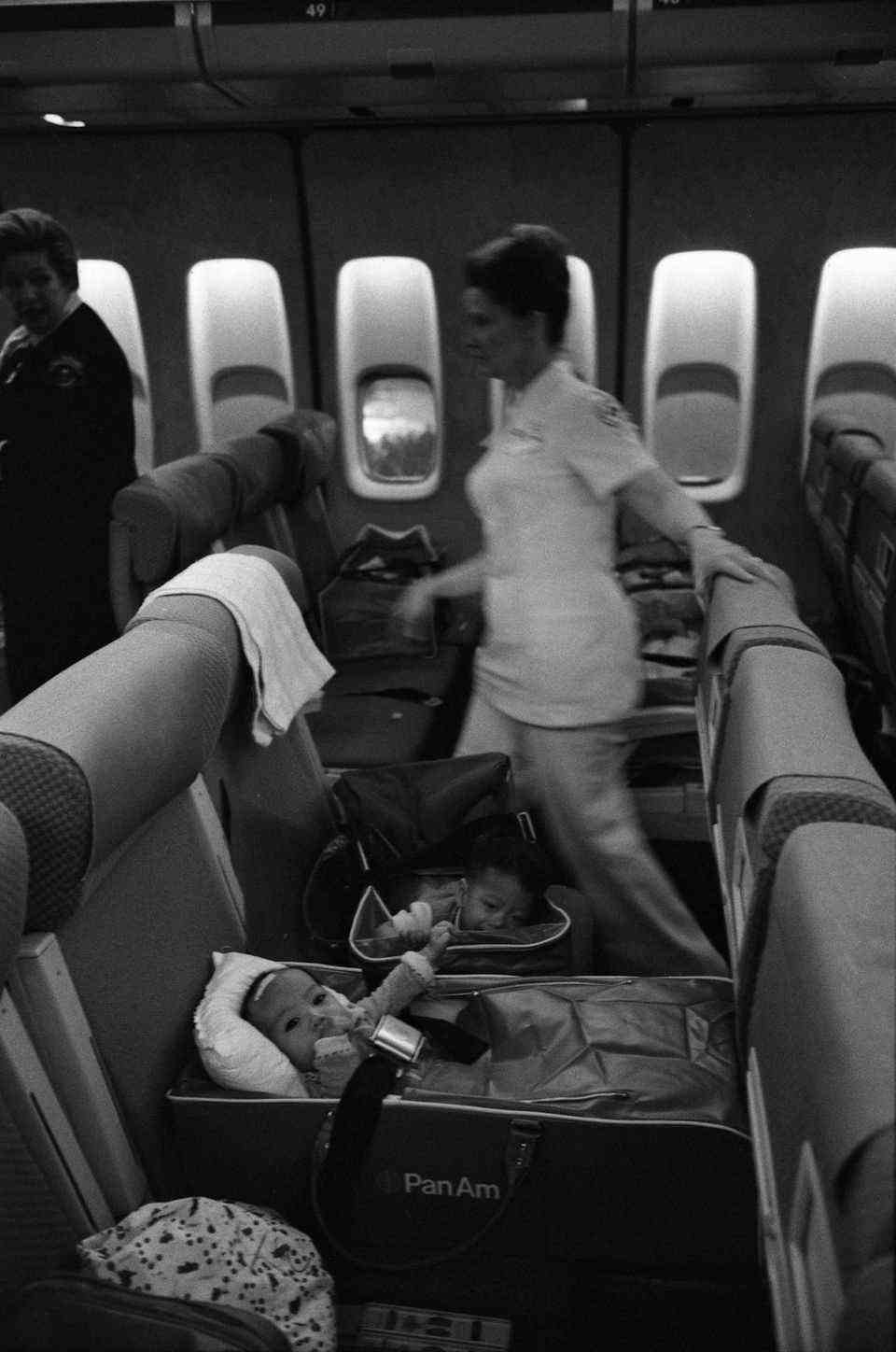 On board a Pan Am Boieng 747: Nurses and Vietnamese refugee children on an Operation Babylift flight shortly before arriving at San Francisco International Airport.
