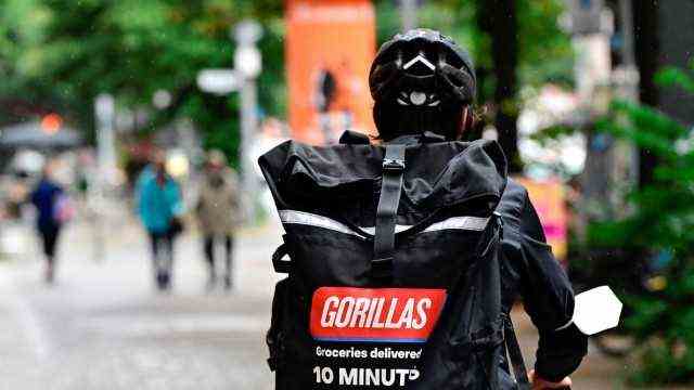 Delivery services: To customers in ten minutes: Bicycle courier with a gorillas backpack in Berlin.