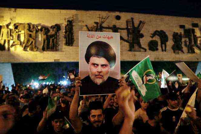 Supporters of Moqtada Al-Sadr celebrate, in Tahir Square in Baghdad, on October 11, 2021, the victory of the Shiite leader's movement in the legislative elections.