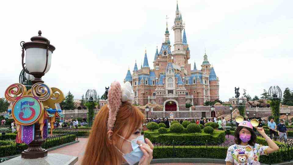 Archive Photo: Tourists wear masks at Shanghai Disneyland on June 5, 2021.