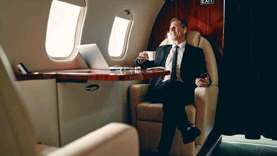 A businessman is sitting in a private plane