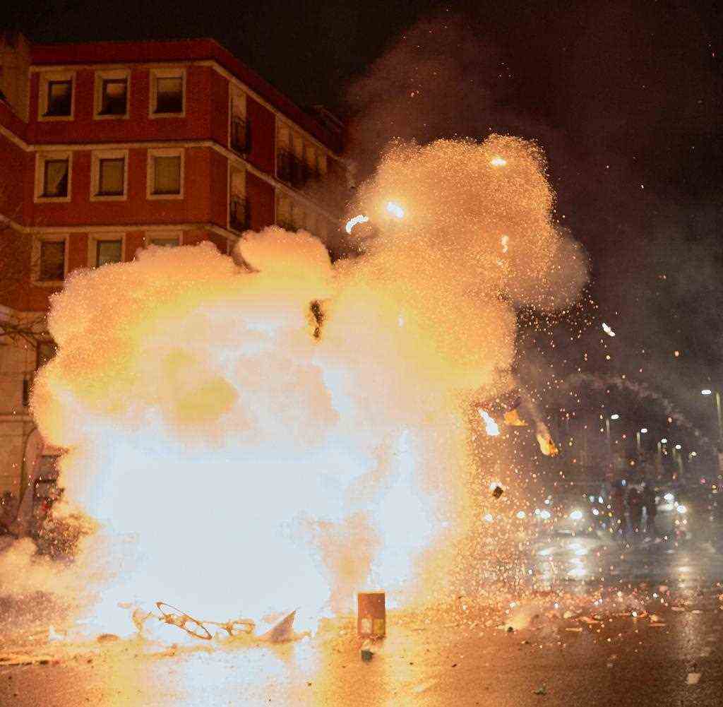 A burning barricade in The Hague.  Fireworks explode