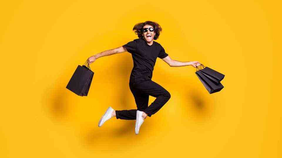Early Black Friday offers on Amazon: A man dressed in black leaps into the air for joy.