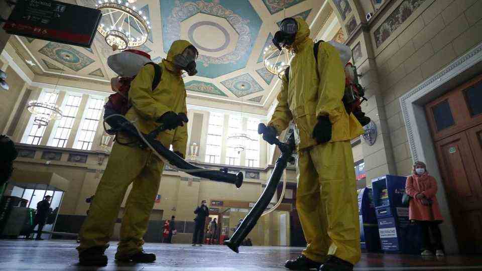 A disinfection team at the Kiev train station in Moscow