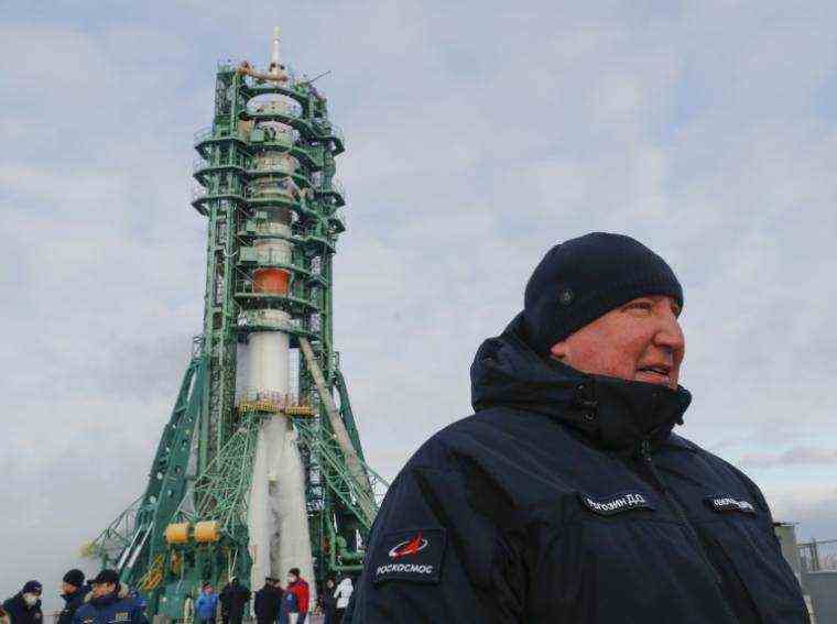 The head of the Russian Space Agency Dmitry Rogozin stands on December 8, 2021 at the Baikonur Cosmodrome in Kazakhstan, in front of the rocket that will send Japanese billionaire Yusaku Maezawa into space (POOL / SHAMIL ZHUMATOV)