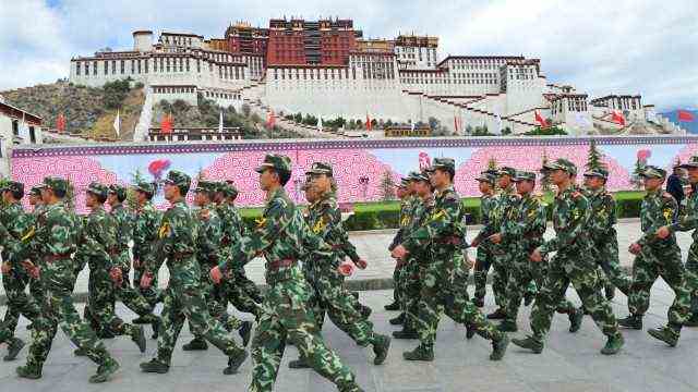 China and Tibet: Intimidating Presence: Chinese police paramilitary forces patrol the sanctuary of Tibetan culture: the Potala Palace in Lhasa during the torch relay for the 2008 Summer Olympics.