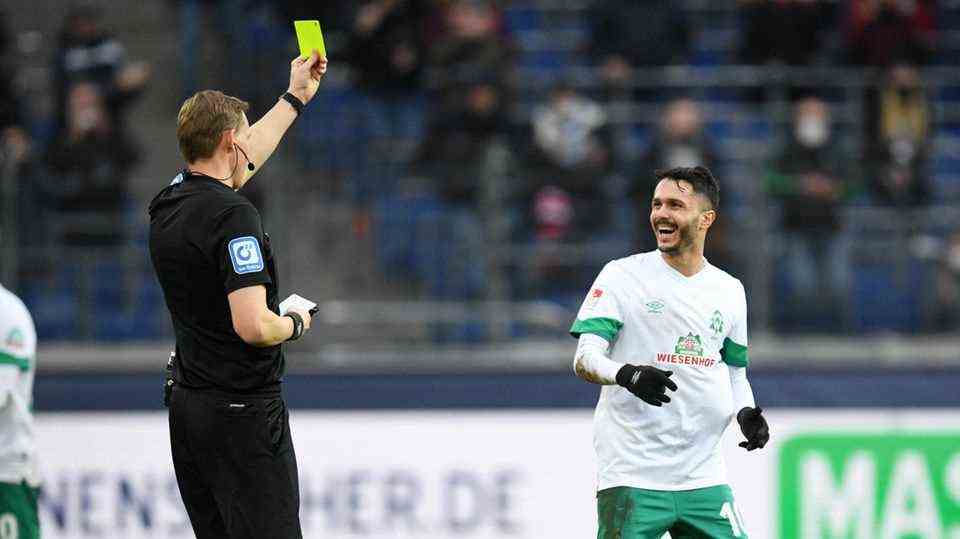 Bremen's Bittencourt laughs at the yellow card from referee Martin Petersen