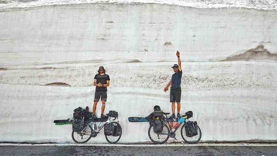 Image 1 of the photo gallery to click: The two protagonists: Jochen Mesle and Max Kroneck take a break on their bike and ski tour through the Alps at the Great St. Bernhard.  Your journey began on April 26, 2018 and lasted 42 days.