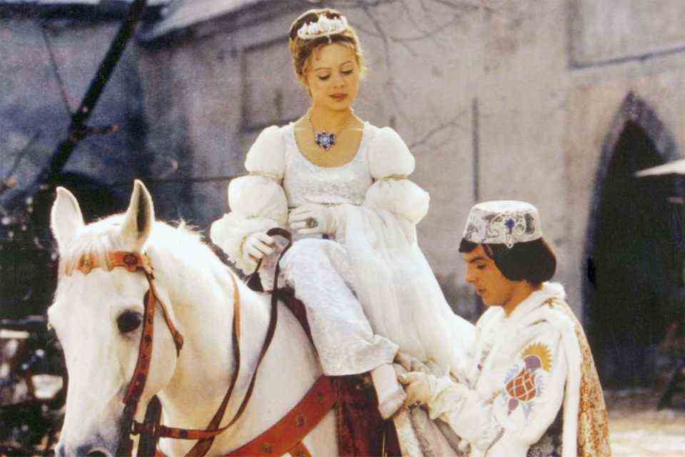 The prince (Pavel Trávnícek) adjusts Cinderella (Libuse Safránková) the lost shoe.