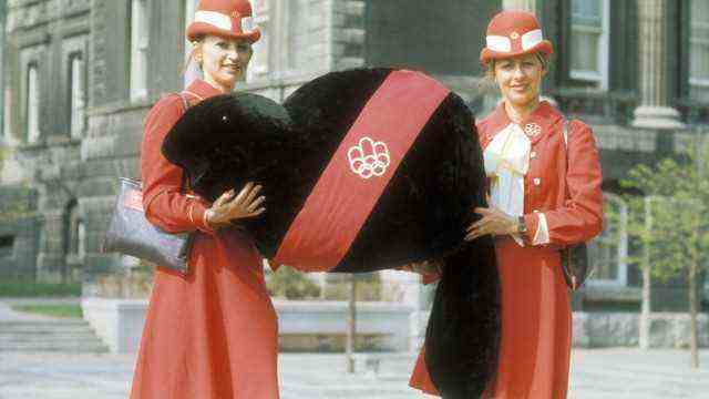 Munich 1972: Hostesses with a soft toy variant of the mascot Amik during the 1976 Olympic Games in Montreal.