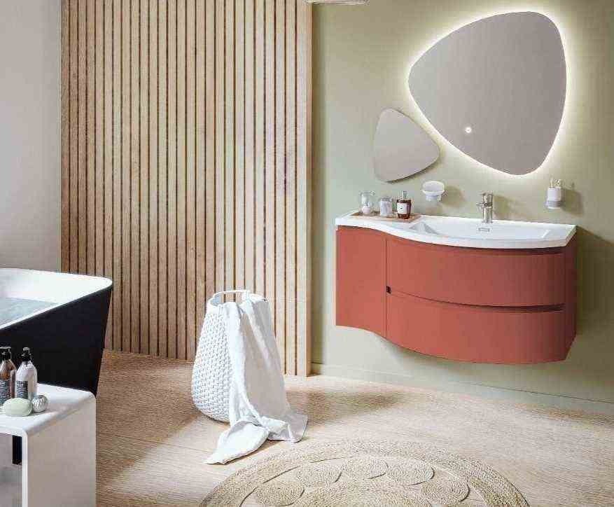 A bathroom in terracotta, soft green and wood 