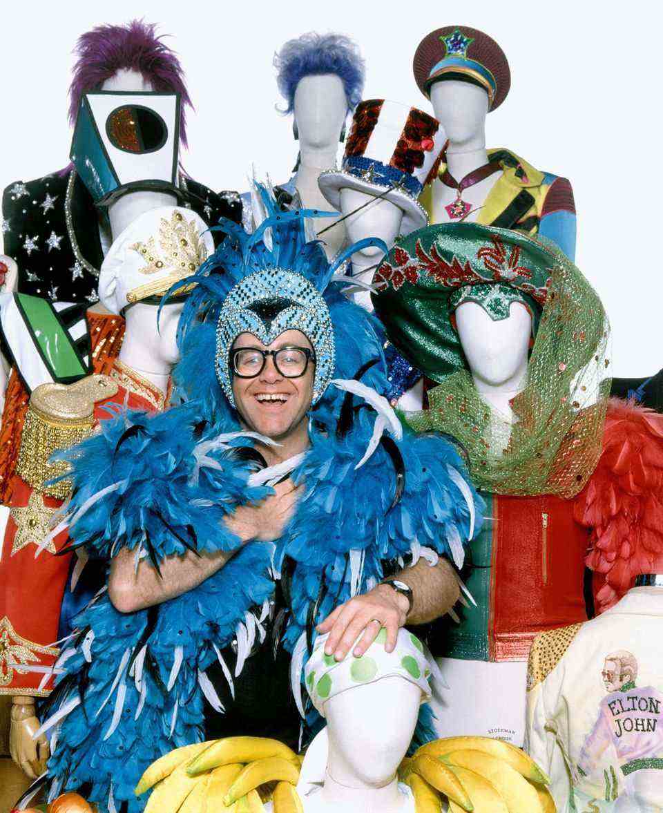 Elton John in a blue feather costume
