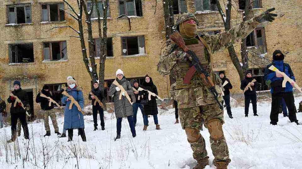 Kiev, Ukraine.  A member of the public initiative "Total Resistance" teaches civilians how to use weapons.  Also part of the training are saint services, tactics and obstacle courses.  At least 15 civilians are practicing here with wooden Kalashnikovs.