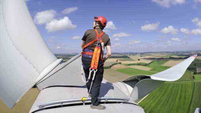 Wind power: where is it blowing?  A man stands on the nacelle of a wind turbine in the Harenzhofen wind farm.