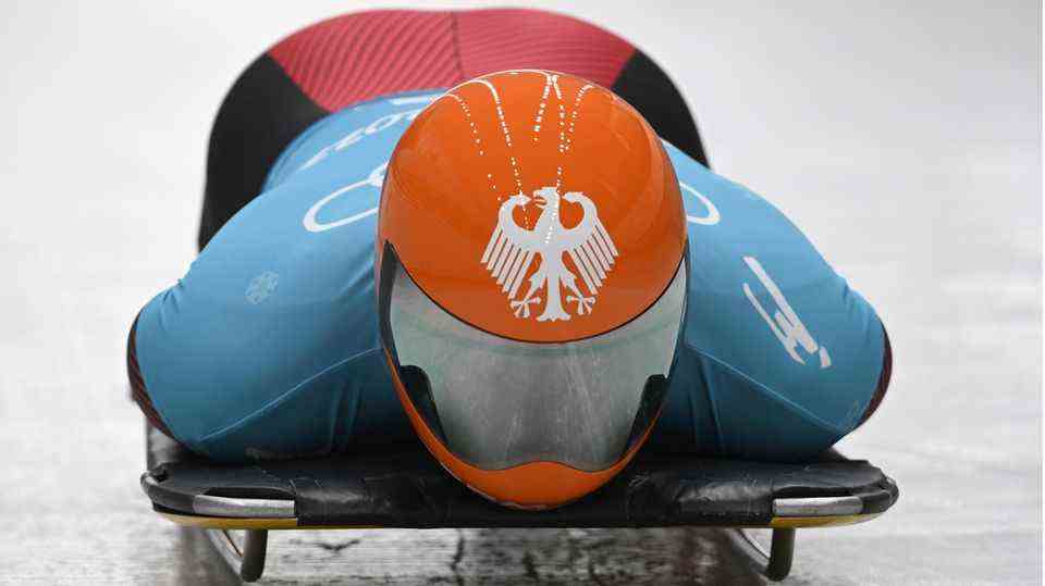 Germany's Christopher Grotheer sets a track record in the first men's skeleton run at the 2022 Olympics in Beijing