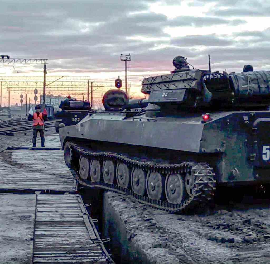 In this photo taken from video provided by the Russian Defense Ministry Press Service on Tuesday, Feb. 15, 2022, Russian armored vehicles are loaded onto railway platforms after the end of military drills in South Russia.  In what could be another sign that the Kremlin would like to lower the temperature, Russia's Defense Ministry announced Tuesday that some units participating in military exercises would begin returning to their bases.  (Russian Defense Ministry Press Service via AP)