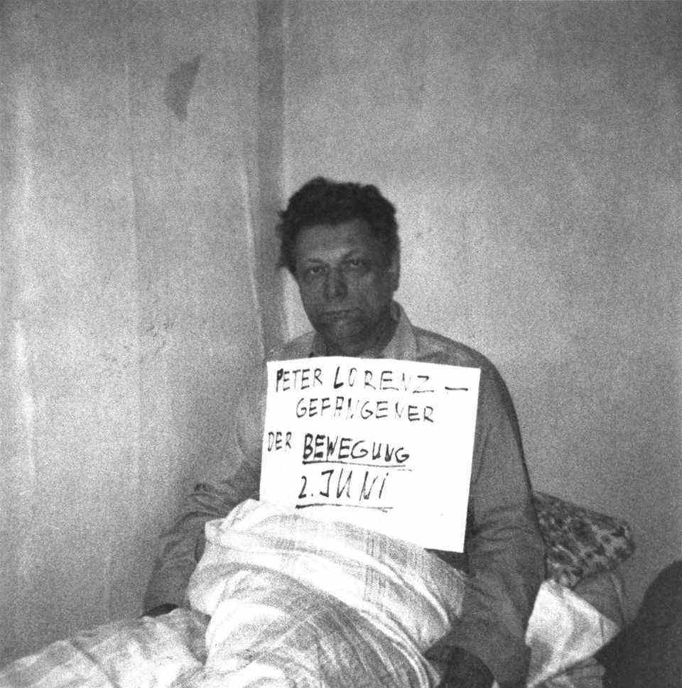 The first photo of the kidnapped Peter Lorenz shows him with a cardboard sign around his neck.