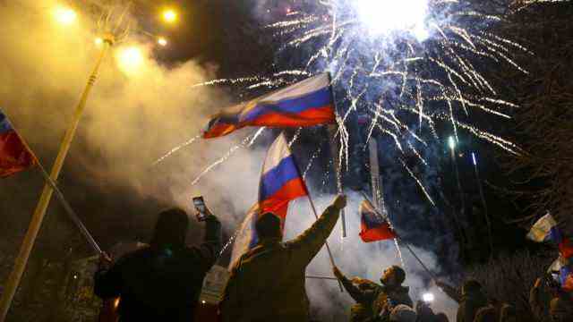 Angry speech: Separatists in the city of Donetsk celebrate with fireworks and Russian flags that Vladimir Putin now wants to treat the Ukrainian region as a separate state.