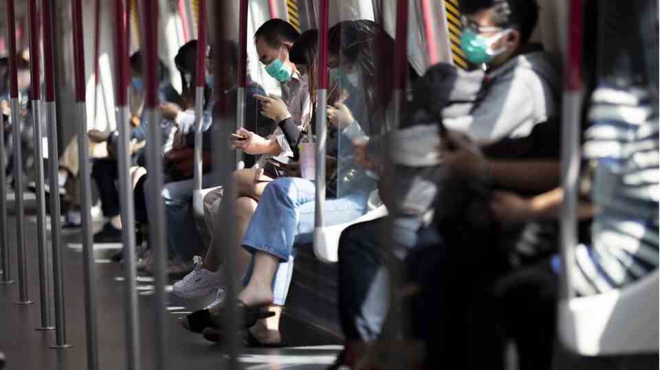 Passengers on a subway train in Hong Kong