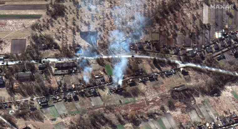 Satellite image provided, February 28, 2022, by Maxar Technologies of part of the Russian military convoy and burnt houses near Ivankiv, northwest of Kiev (Satellite image ©2022 Maxar Technologies / - )