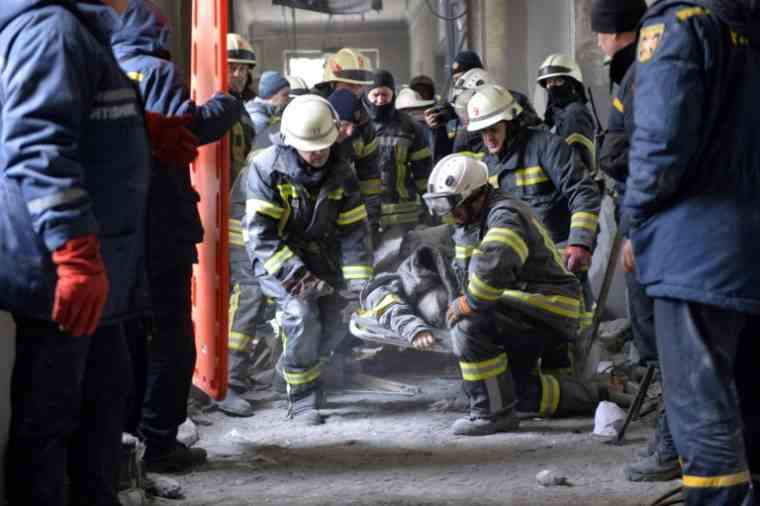 Firefighters evacuate the body of a victim of the bombing of the regional prefecture, on March 1, 2022 in Kharkiv (AFP / Sergey BOBOK)