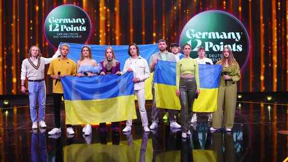 The preliminary decision participants on stage with Ukrainian flags © NDR Photo: Mairena Torres Schuster