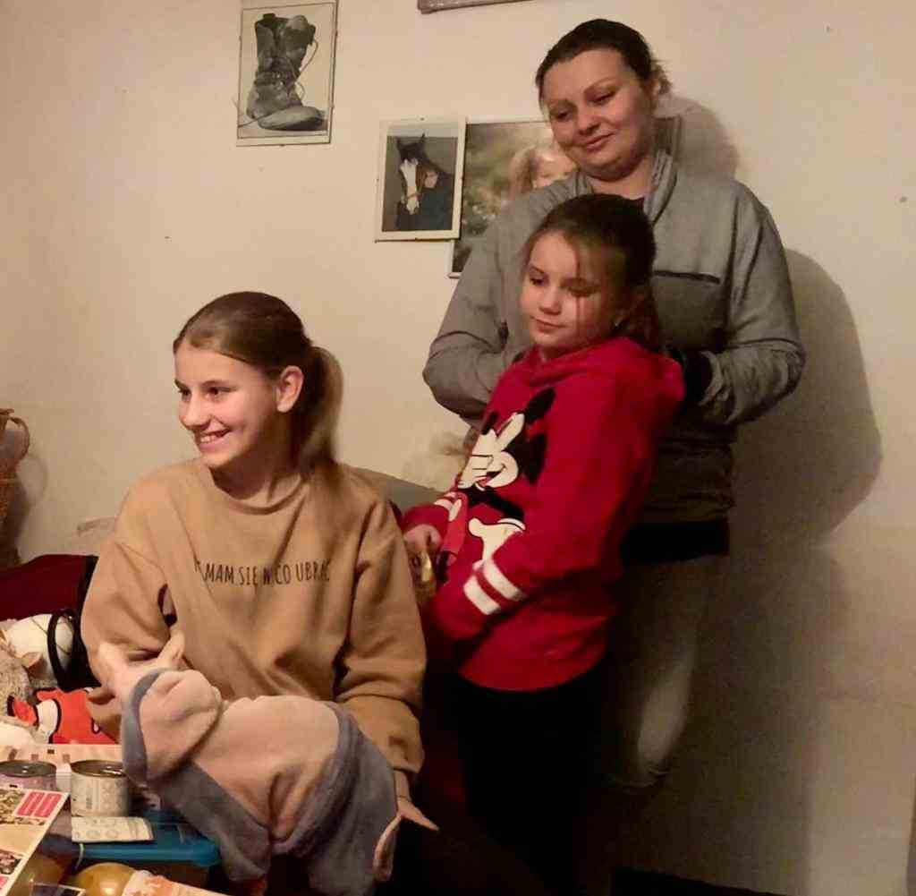 Daughters Violetta and Eseniya Pavlenko unwrap presents