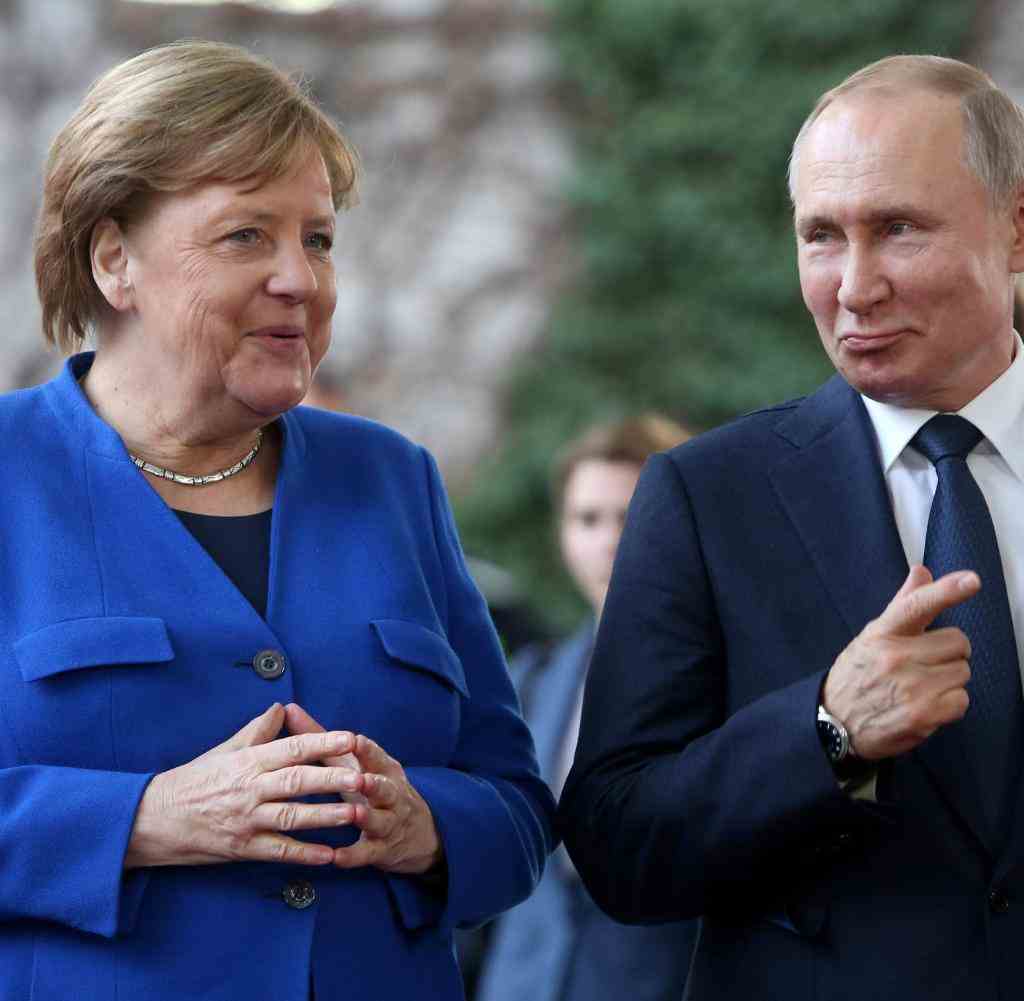 BERLIN, GERMANY - JANUARY 19: German Chancellor Angela Merkel (CDU, L) greets Russian President Vladimir Putin as he arrives for an international summit on securing peace in Libya at the German federal Chancellery on January 19, 2020 in Berlin, Germany. Leaders of nations and organizations linked to the current conflict are meeting to discuss measures towards reaching a consensus between the warring sides and ending hostilities. (Photo by Adam Berry/Getty Images)
