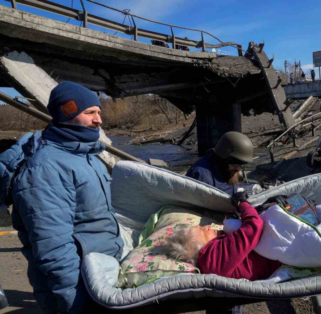Volunteers evacuate an old woman from Irpin near Kyiv