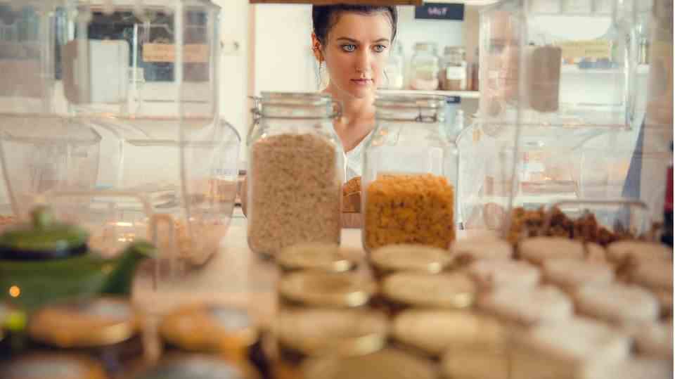 A woman stands in front of her pantry