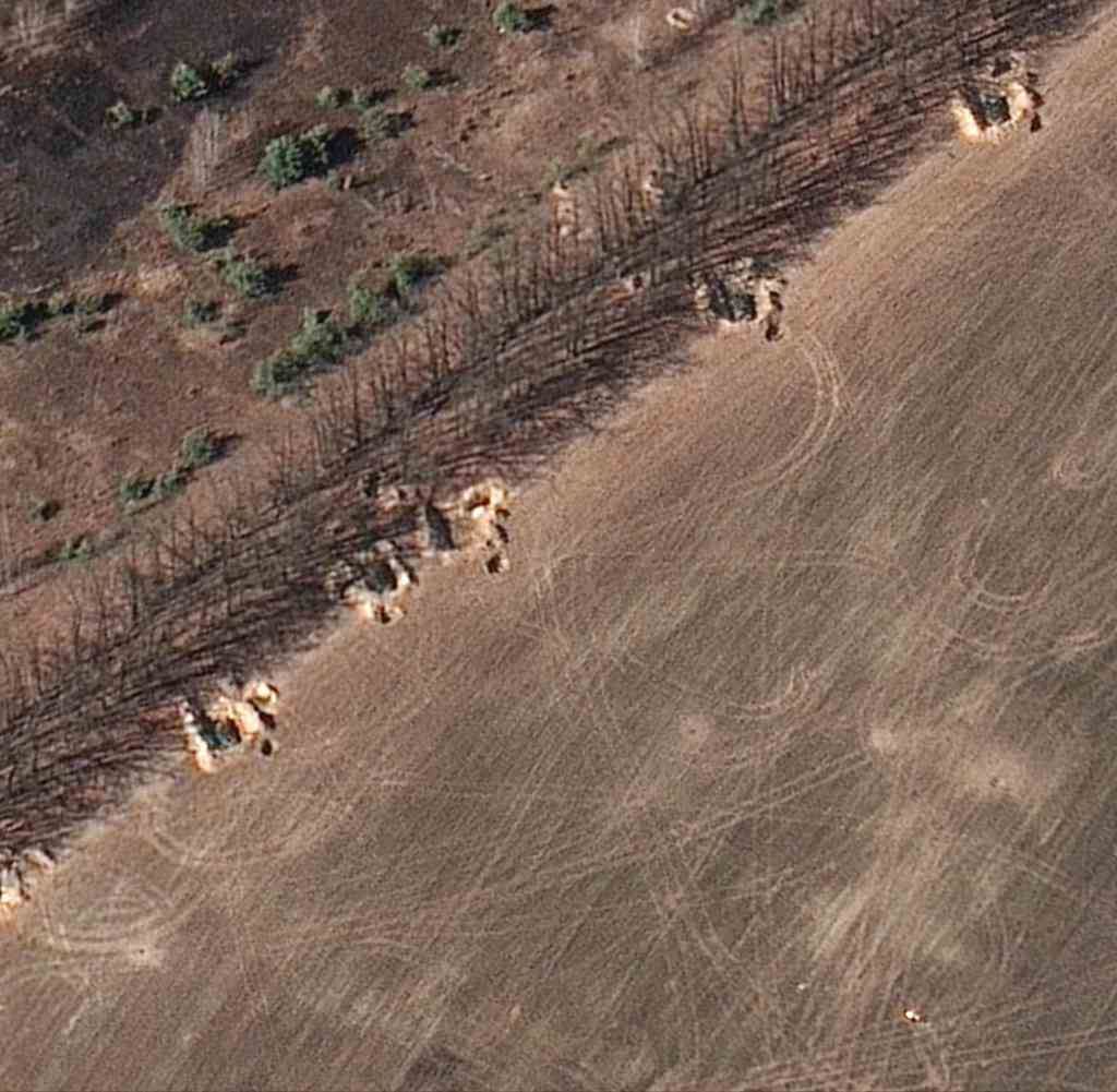 The satellite image from Maxar Technologies shows Russian positions northwest of Kyiv, entrenched behind earthen walls