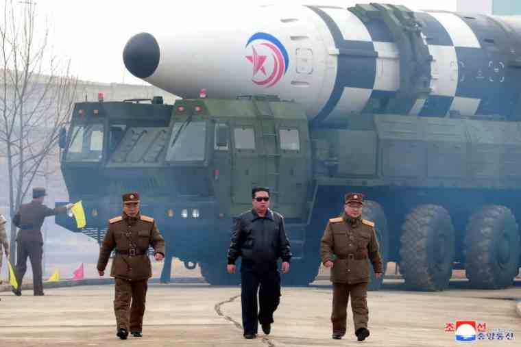 Photo released on March 25, 2022 by North Korean news agency Kcna of North Korean leader Kim Jong Un (c) in front of a Hwasong-17 intercontinental ballistic missile at an unspecified location in North Korea, March 24, 2022 ( KCNA VIA KNS/STR)