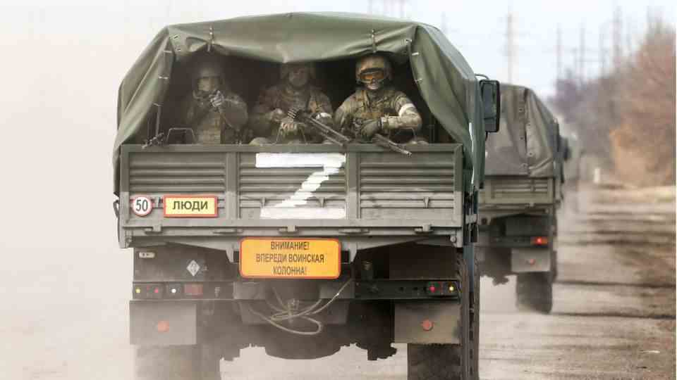 Russian soldiers in a military vehicle.