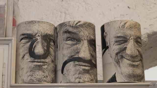 Crafts: Pictures by Alf Lechner that his daughter glued to cans.